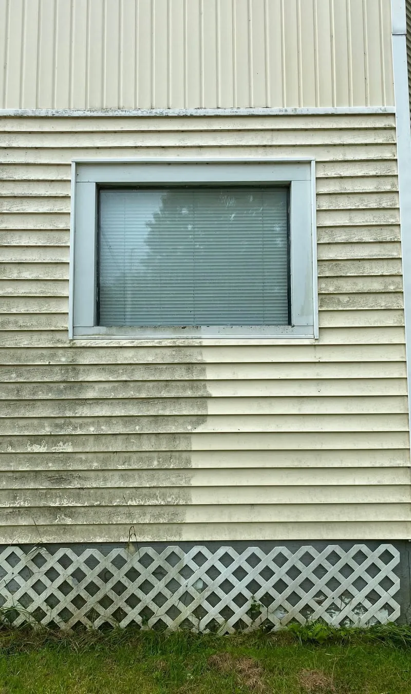 Vinyl siding mid-wash, showing the difference between the dirty and cleaned halves