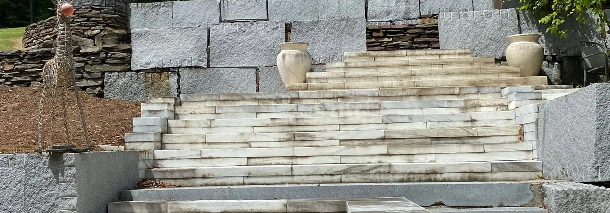 Freshly cleaned bluestone steps and granite retaining wall