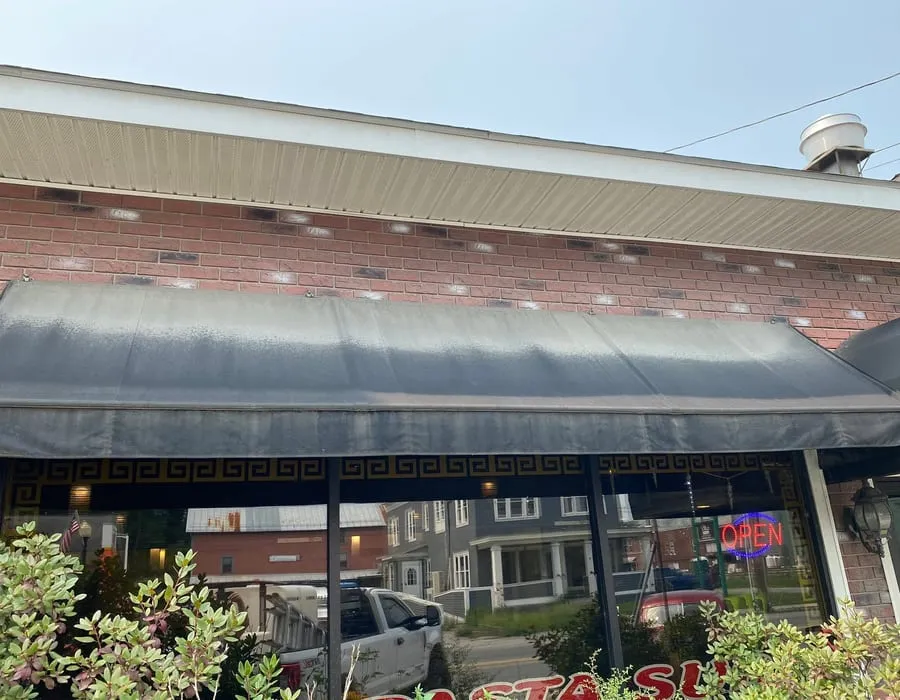 A storefront awning and brickwork after cleaning