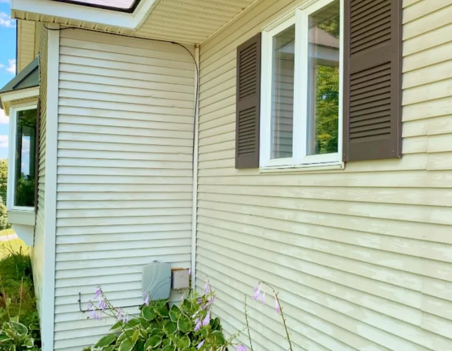 Clean cream siding and white trim after a soft wash