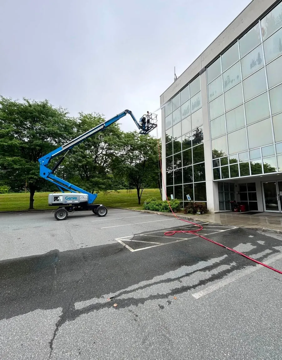 Wash Works cleaning a commercial glass facade from a boom lift
