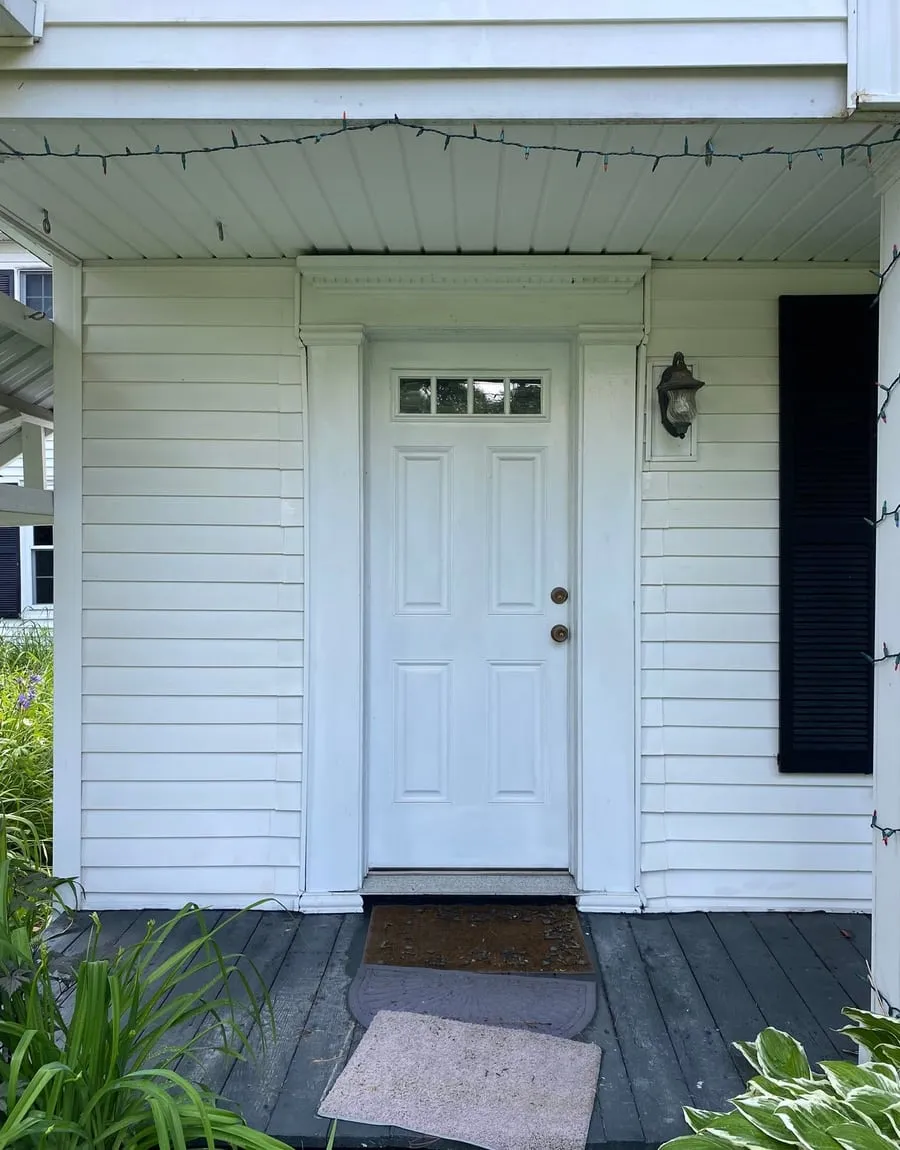 A clean white porch and entry door