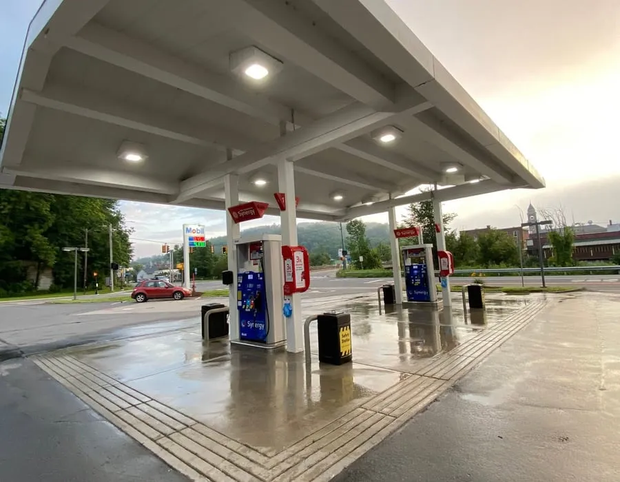 A washed gas station canopy and forecourt