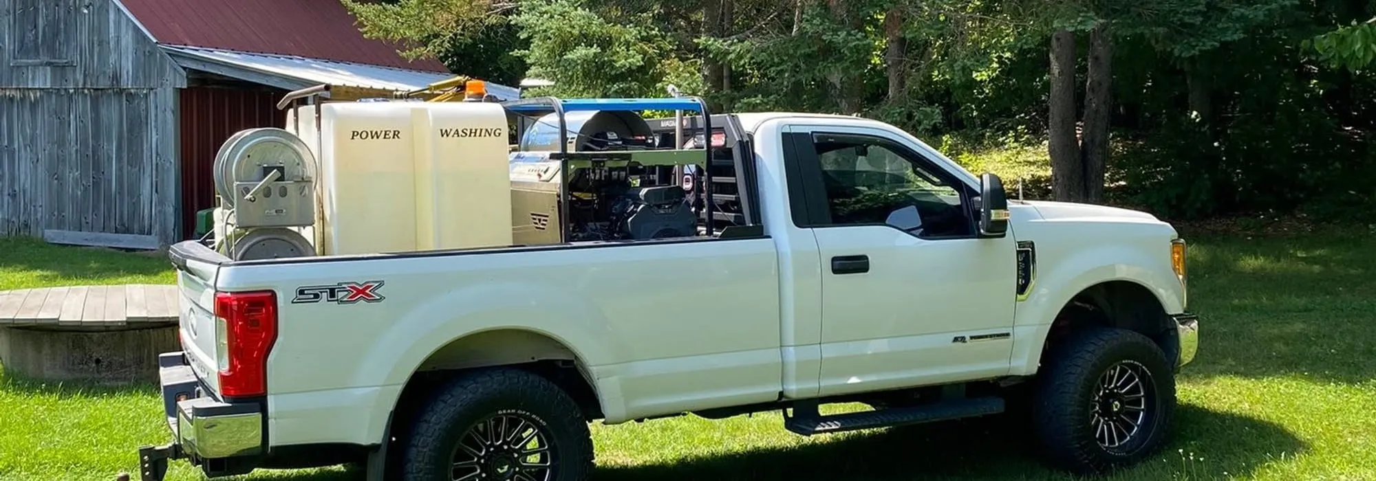 The Wash Works truck loaded with tanks and pressure washing equipment