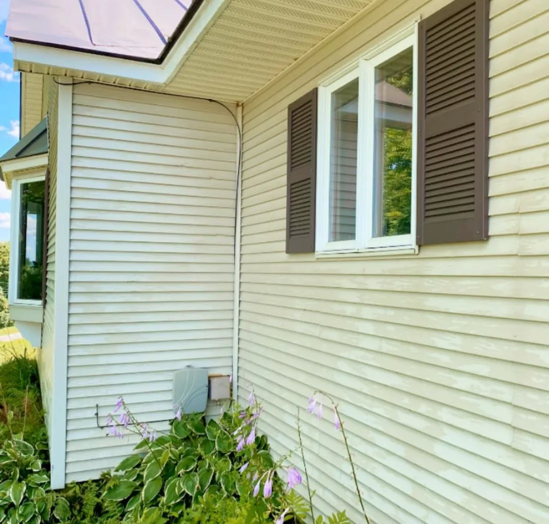 Clean cream-colored siding and white trim after a soft wash